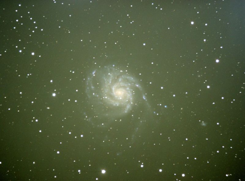 2 sources of unwanted light; a gradient starting at the upper right corner, and light pollution in the form of the typical yellow/brown light. Also visible is vignetting, as seen in the darkening of the corners. Image courtesy of Charles Kuehne.